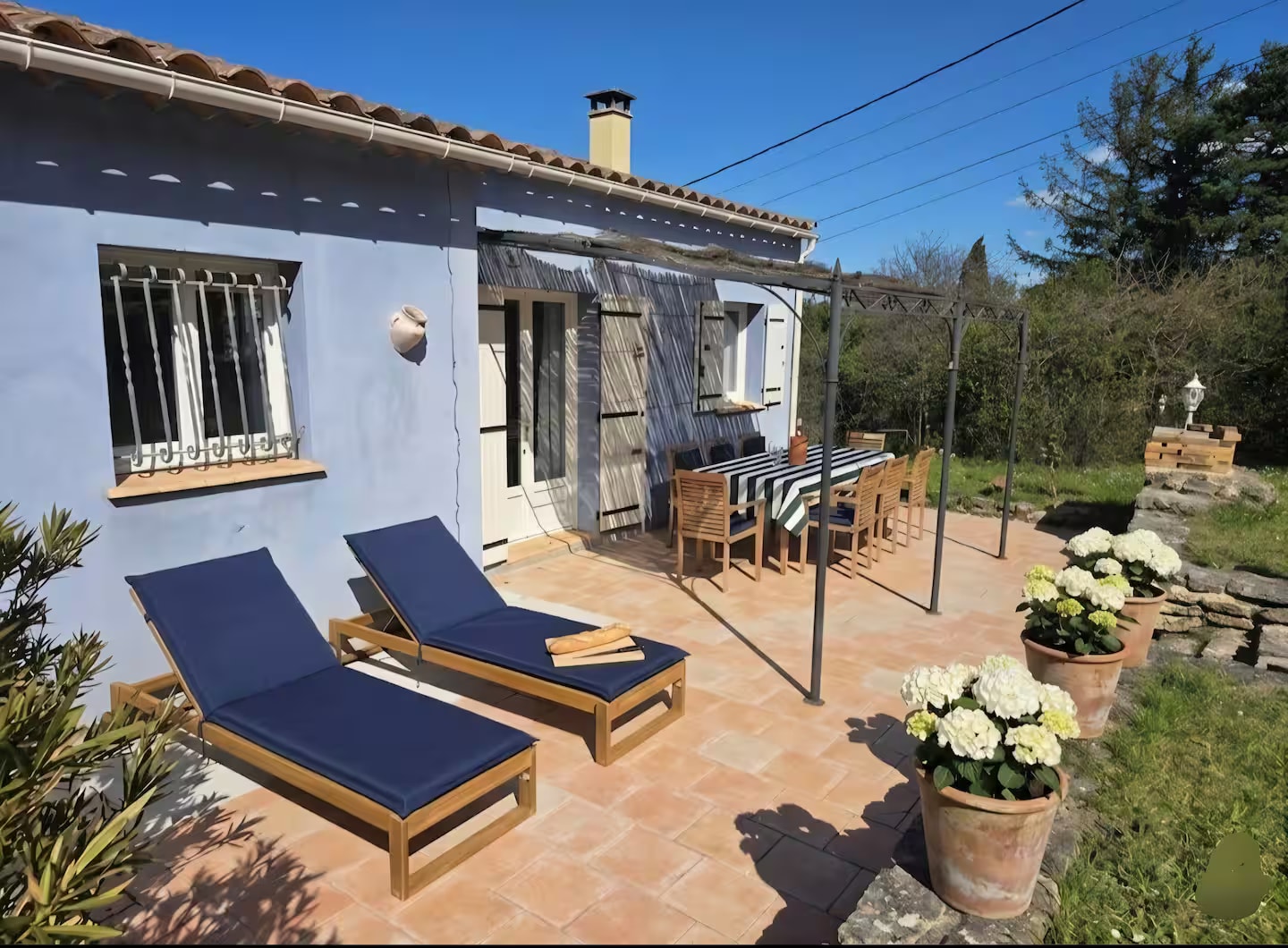 Sun terrace with loungers and outdoor dining